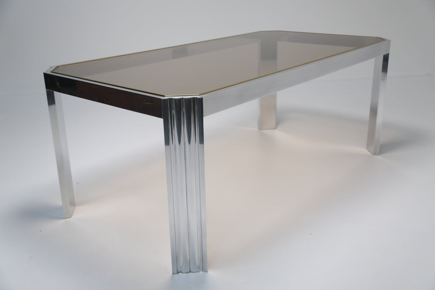 Aluminium dining table with glass top.