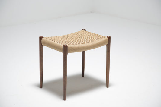 A walnut and papercord stool by Niels Moller.
